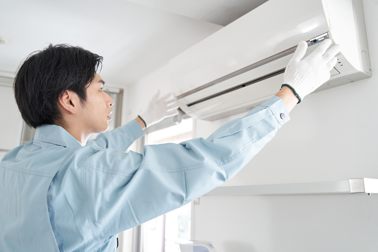 japanese-male-electrical-contractor-checking-for-air-conditioners-for-home-use